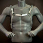 Silver chain harness with metallic discs and rings on dark gray mannequin, edgy and bold style
