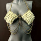 chain bra with beige scale-like plates and gold chains on black mannequin, edgy and bold style