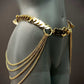 Gold metal chain belt with decorative discs and hanging chains on dark mannequin, elegant and bold