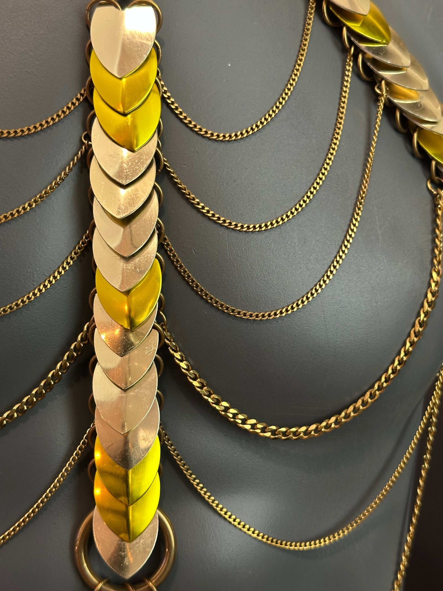 Gold and yellow metal chain body jewelry with heart-shaped scales, elegant and bold design