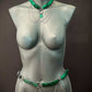 Body chain jewelry in green and silver with geo style on gray mannequin, bold and elegant