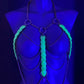 Body chain harness with glowing green scales and dark chains on a blue-lit mannequin, edgy and bold