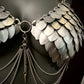 metal scale bra with silver chains and spikes, shiny silver futuristic armor, bold edgy fashion