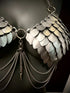 metal scale bra with silver chains and spikes, shiny silver futuristic armor, bold edgy fashion