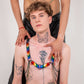 Rainbow heart harness with chains on tattooed shirtless man, modern colorful style, confident vibe